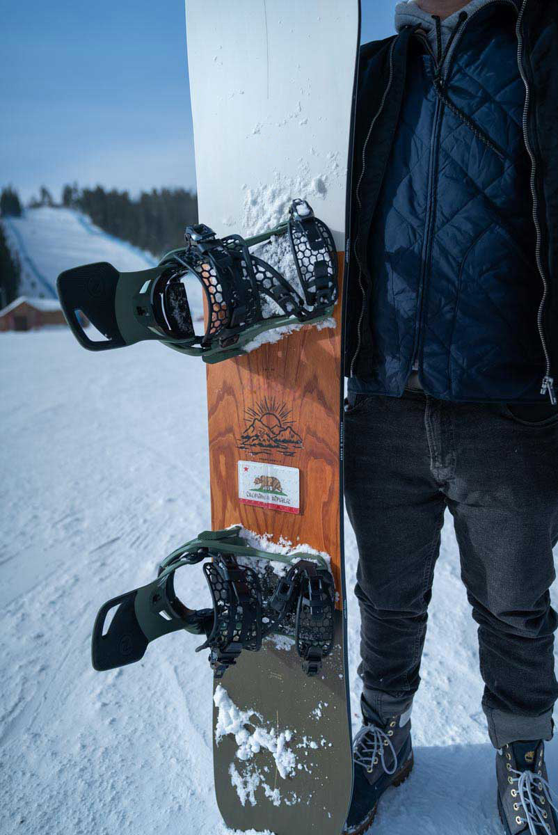 california flag snowboard stomp pad being held up vertically