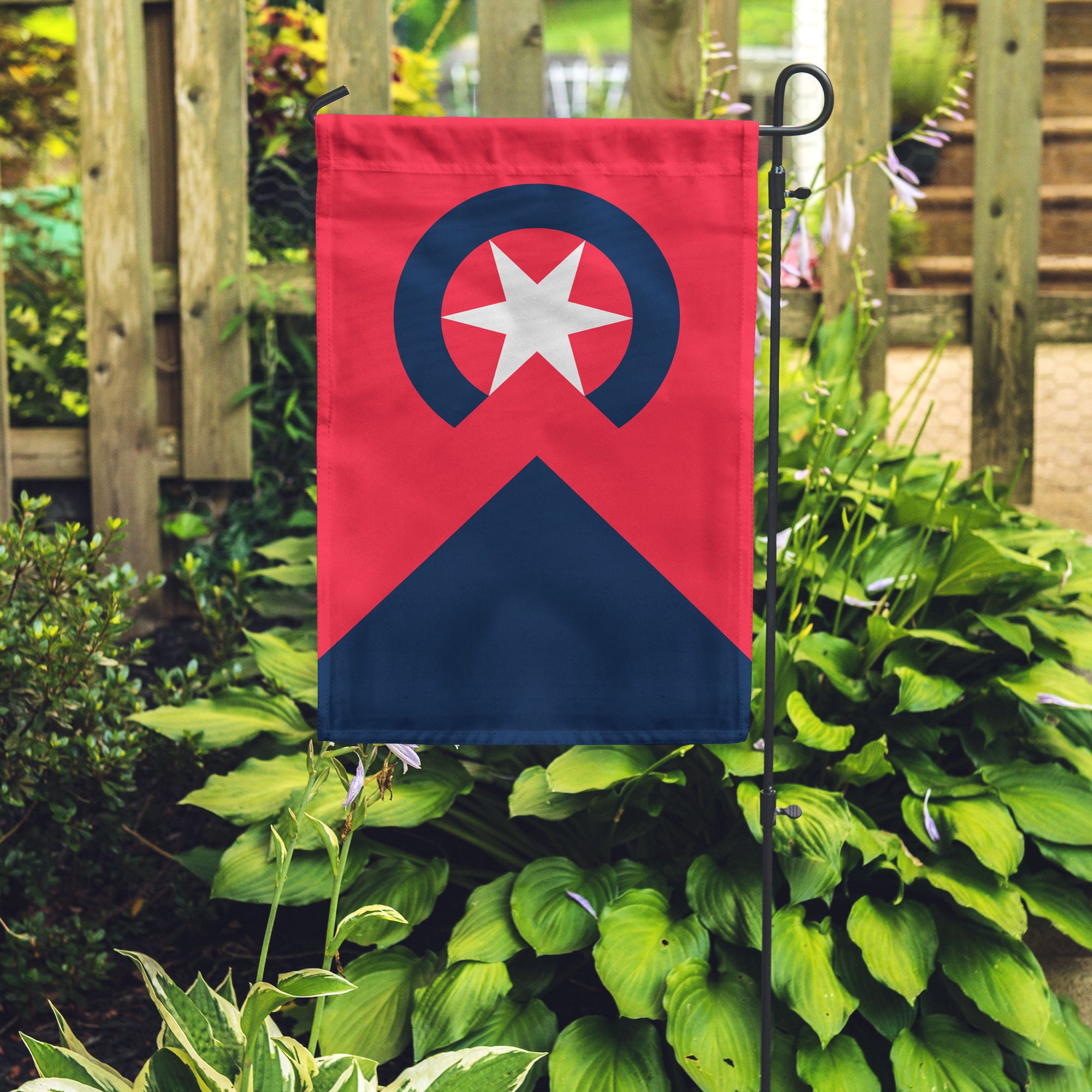 People's Flag of Cleveland vertical Garden Flag in a garden