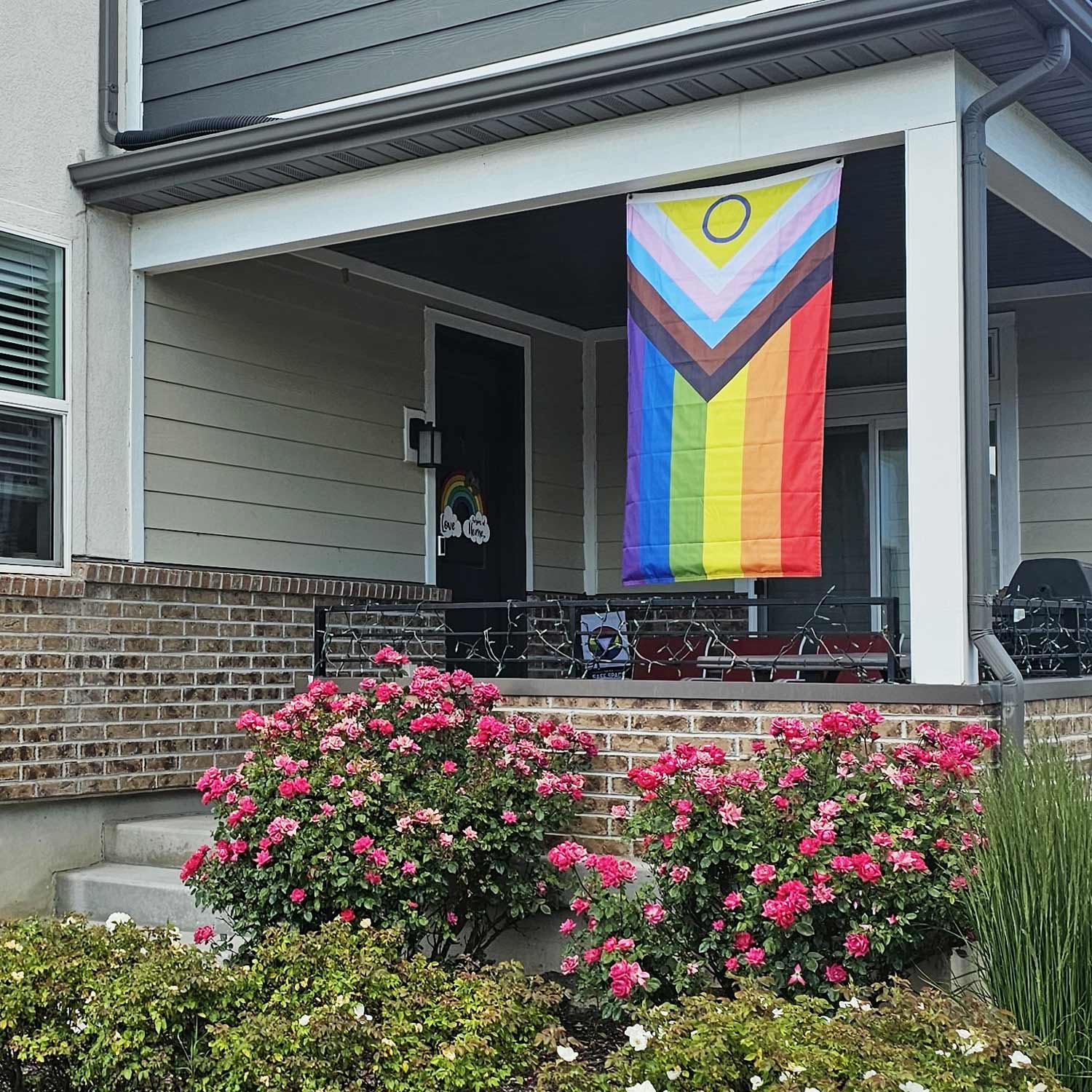 Intersex Progress Pride Flag by Flags For Good hanging vertically on a porch