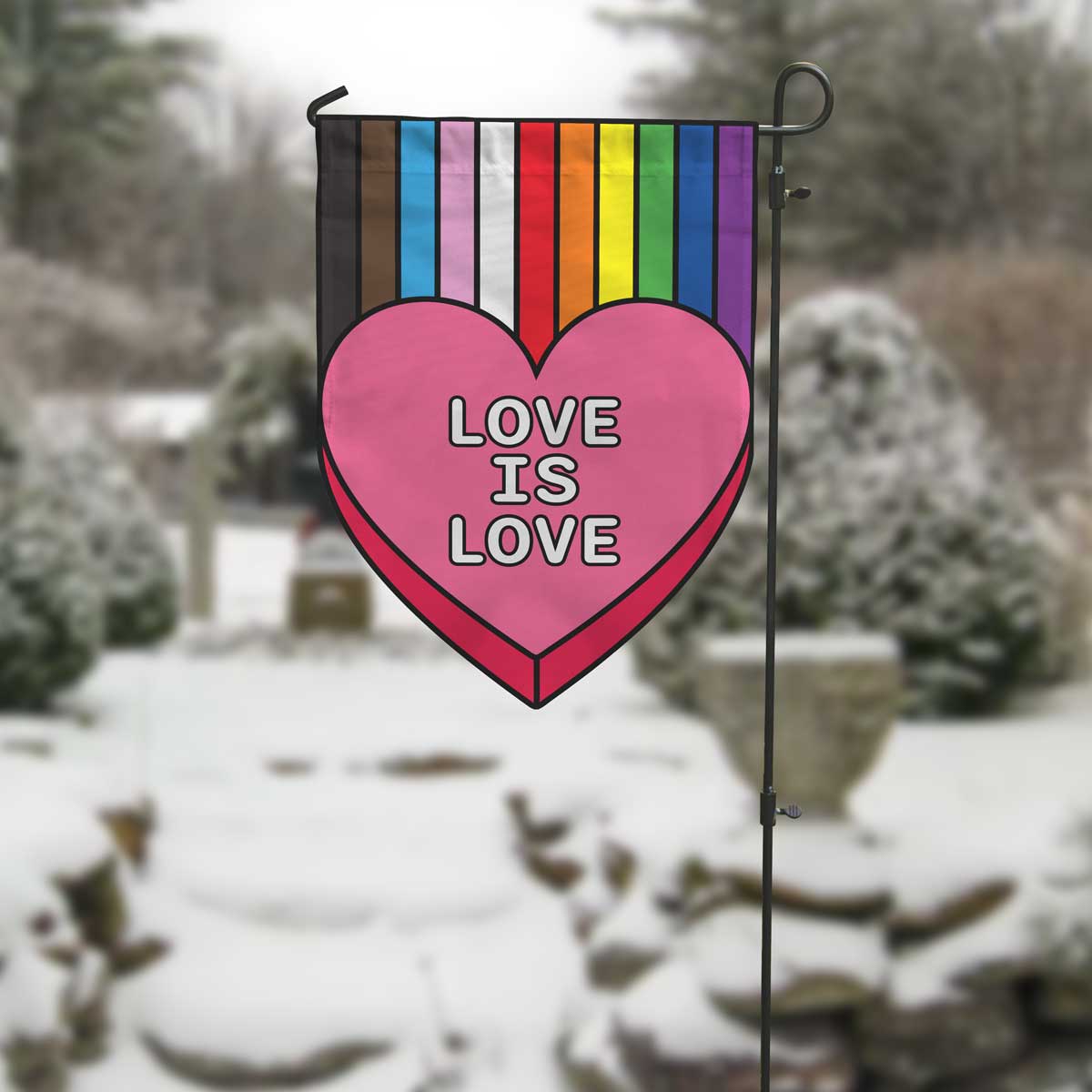 love is love heart with rainbow garden flag in winter setting