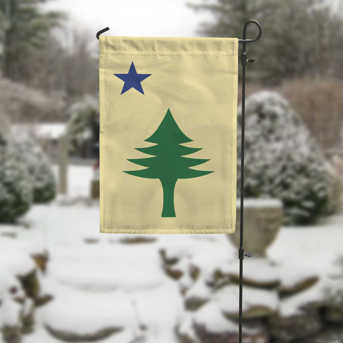 Maine 1901 garden flag with maritime tree produced by flags for good in a winter setting