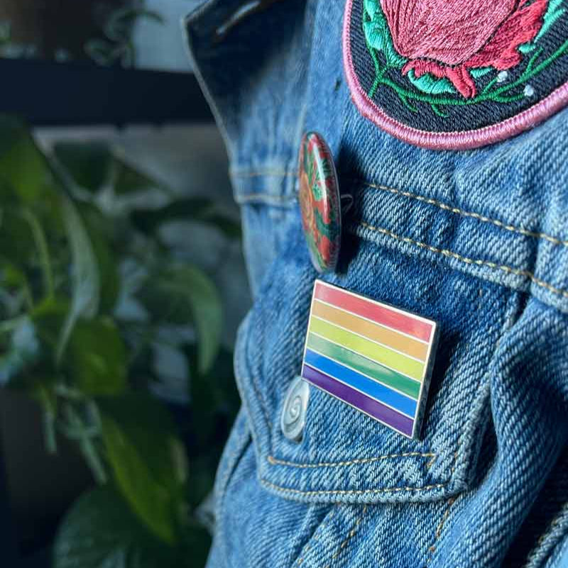 Rainbow Pride Flag Enamel Pin on a jean jacket