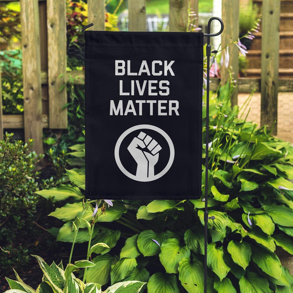 BLM garden flag placed in a garden