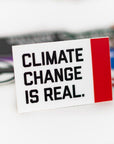 Climate Change Is Real Sticker among other assorted stickers