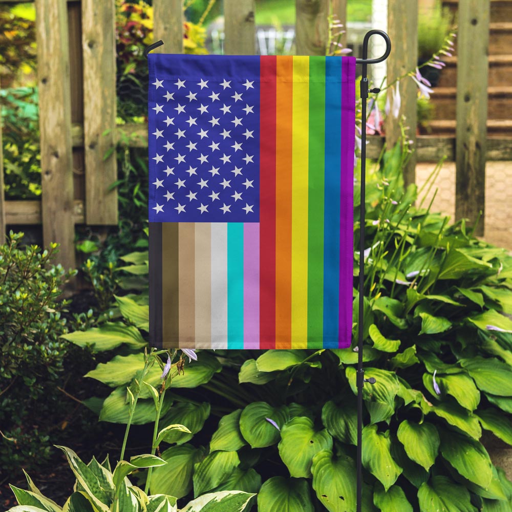 "for all" u.s. garden flag placed in a garden