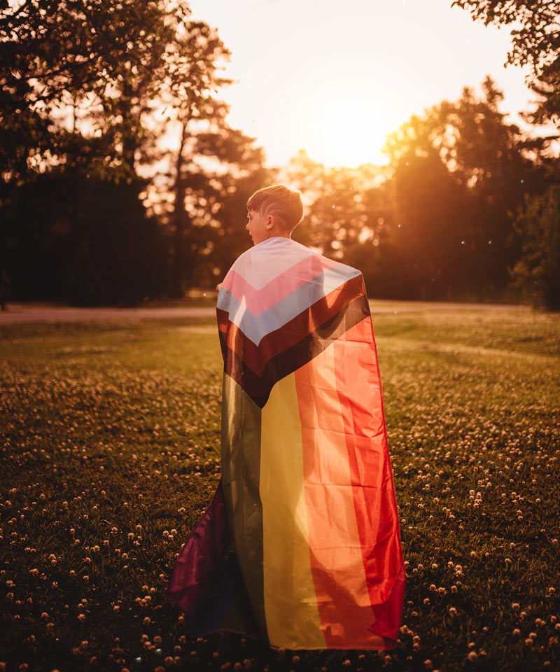 Progress Pride Flag on the back of a child
