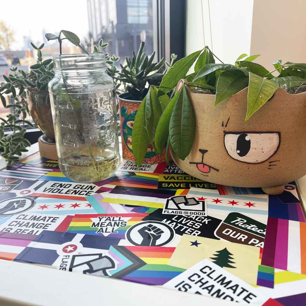 Flags For Good Stickers on a surface with potted plants