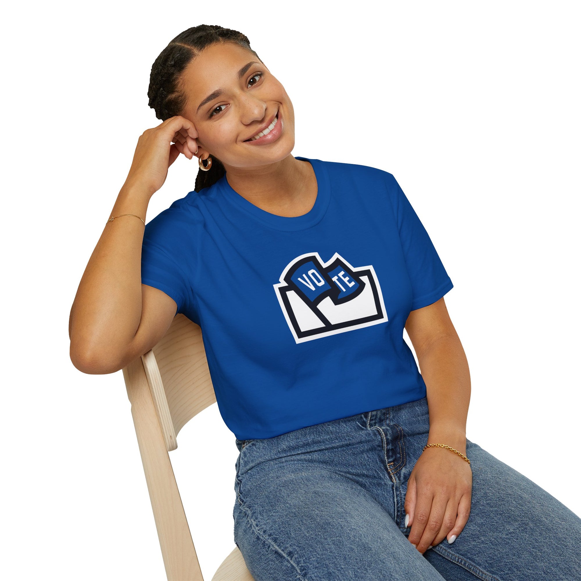 Flags For Good logo with "VOTE" inside on a blue shirt being worn by a woman sitting
