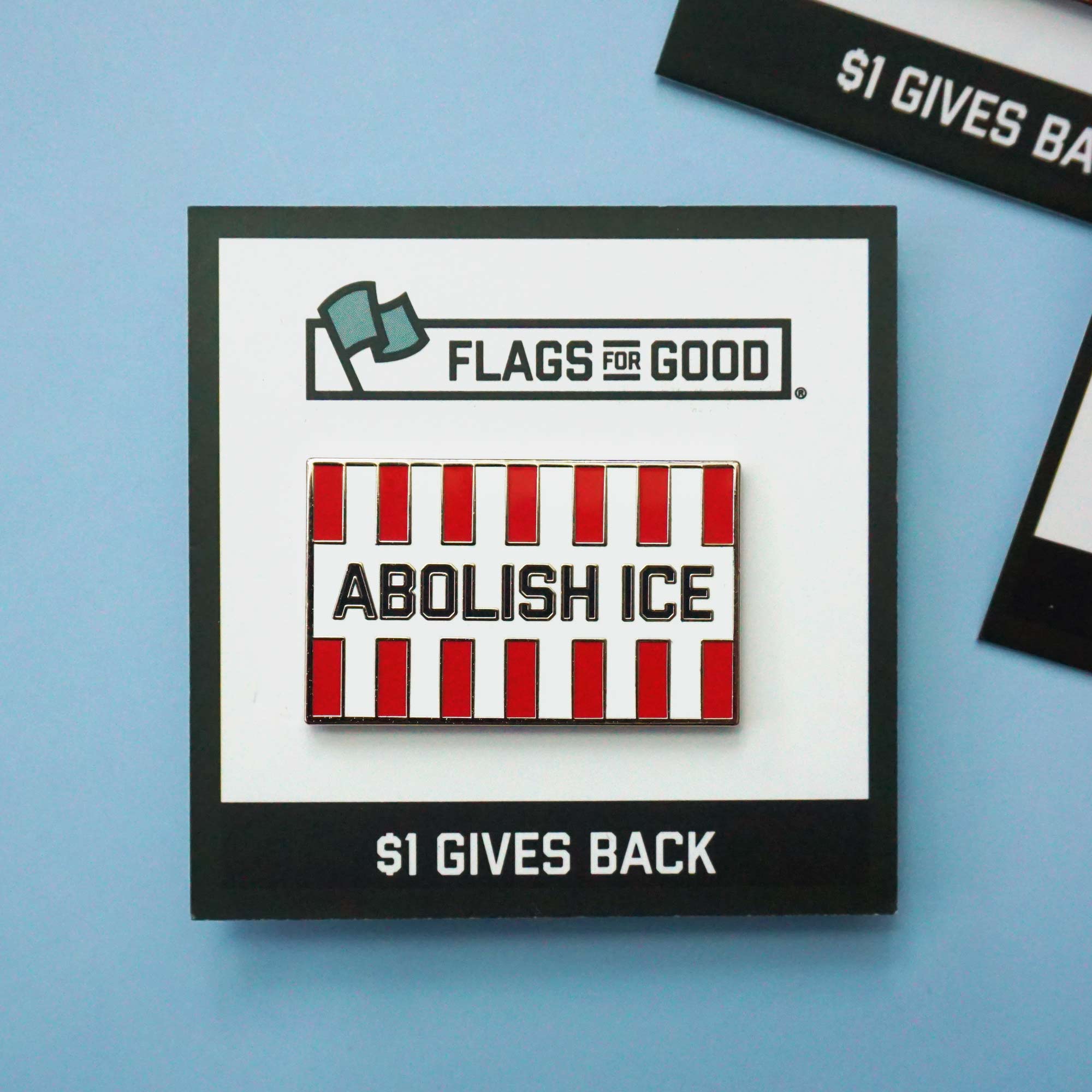 Pin with 'Abolish ICE' message on a blue background