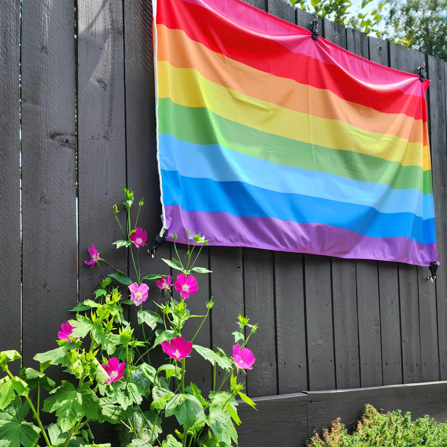 Original 8-stripe Gilbert Baker LGBTQ+ Pride Flag on a fence