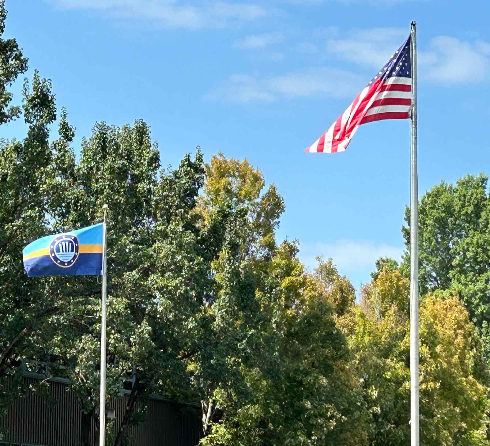 An Evansville Indiana Flag on a flag pole next to the American Flag