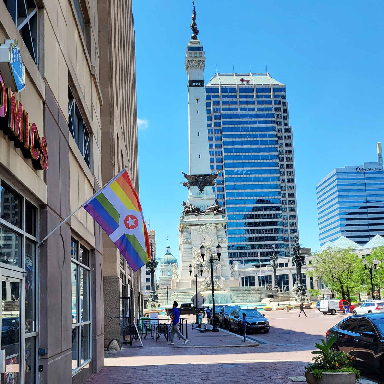 Rainbow Indianapolis Flag by Flags For Good flying on a flag pole near the Indy Circle Monument.