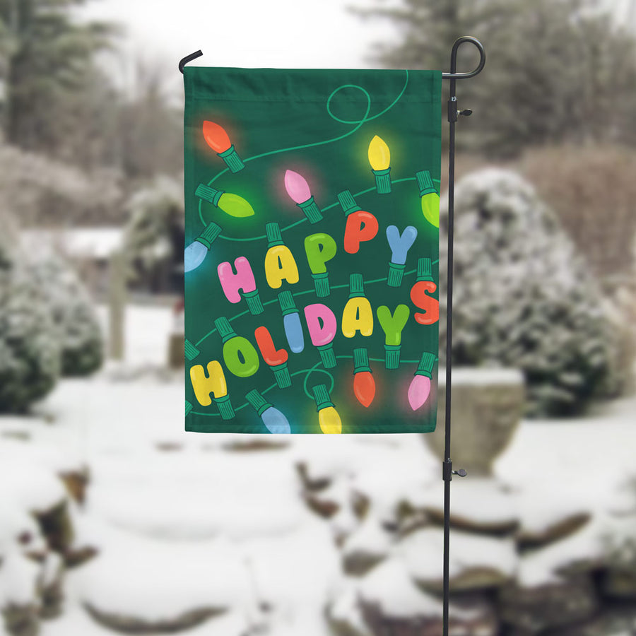 happy holidays garden flag in winter setting