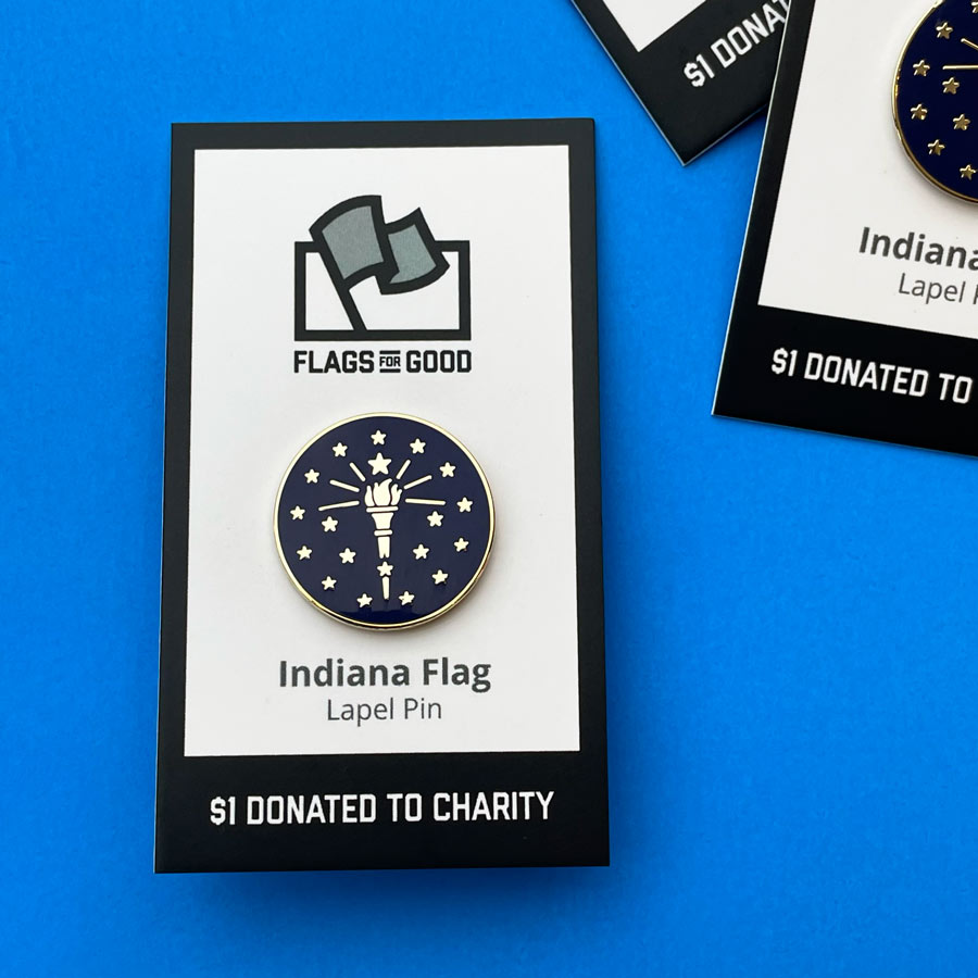 A circle lapet pin with the torch and stars of the Indiana state flag
