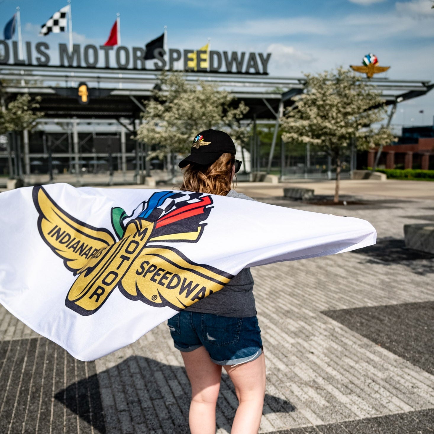 Woman carrying Indianapolis Motor Speedway flag at IMS gate