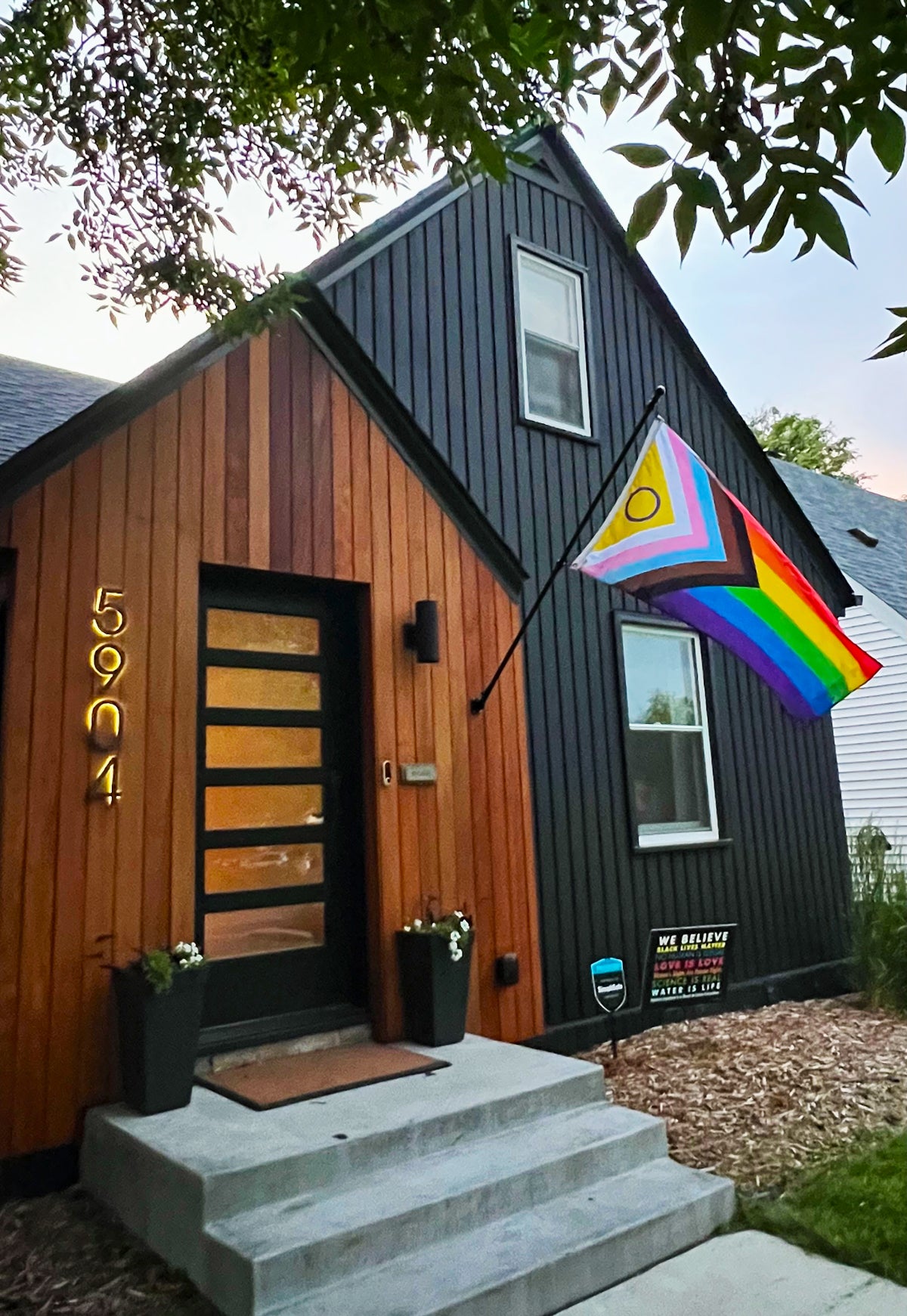 Intersex Progress Pride Flag by Flags For Good flying in front of a modern home.