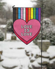 love is love heart with rainbow garden flag in winter setting