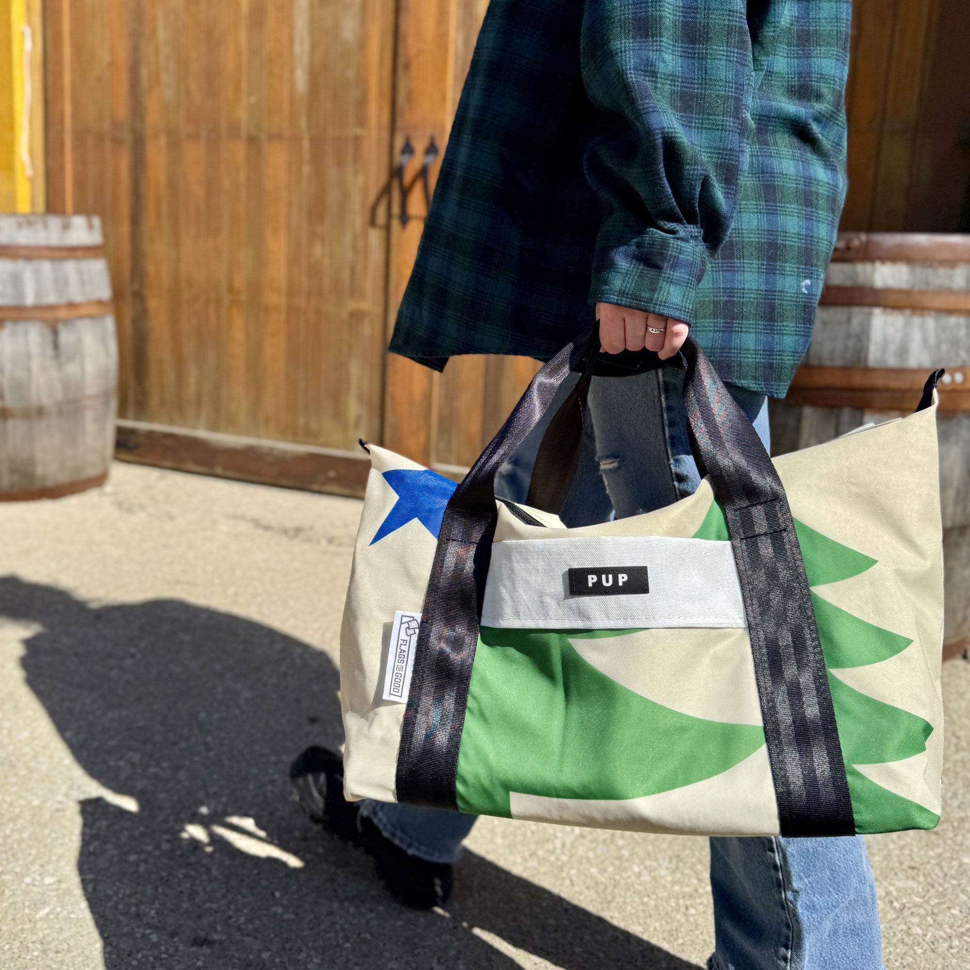 Maine 1901 repurposed flags into a weekender bag being carried by someone