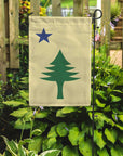 Maine 1901 garden flag with maritime tree produced by flags for good in a garden setting