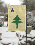Maine 1901 garden flag with maritime tree produced by flags for good in a winter setting