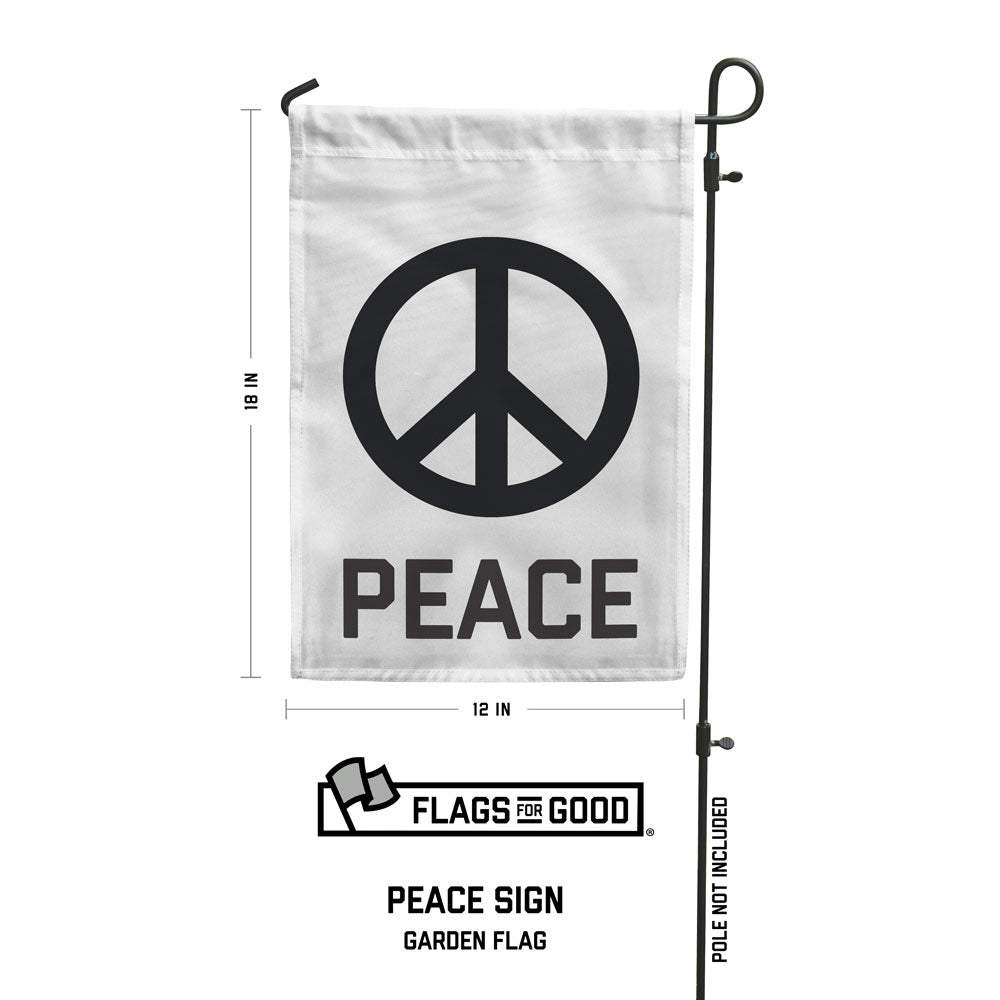 A white rectangular garden flag with a peace sign and the word 'PEACE' printed below it, mounted on a metal pole.