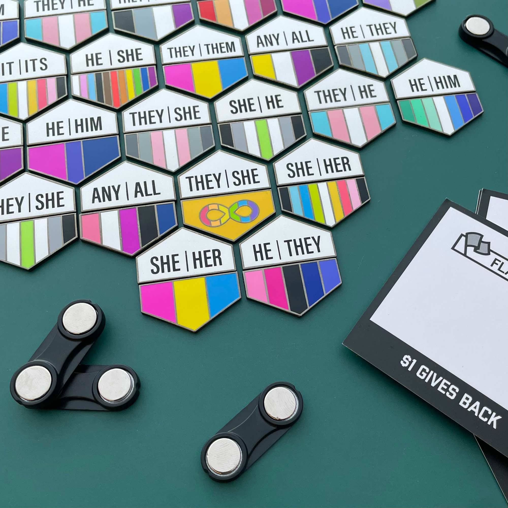 Hexagonal pins with pronoun pins on a green background