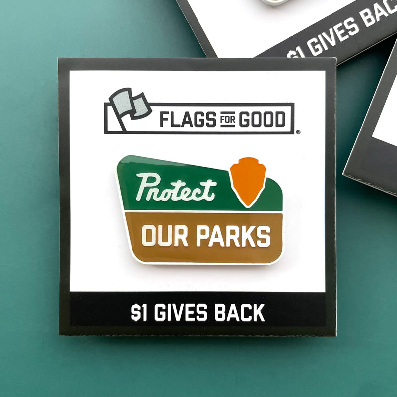 Design by Flags for Good, protect our parks badge enamel pin on a green background