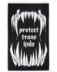 Double - Sided that reads "protect trans kids" with monster like pointy teeth on top and bottom