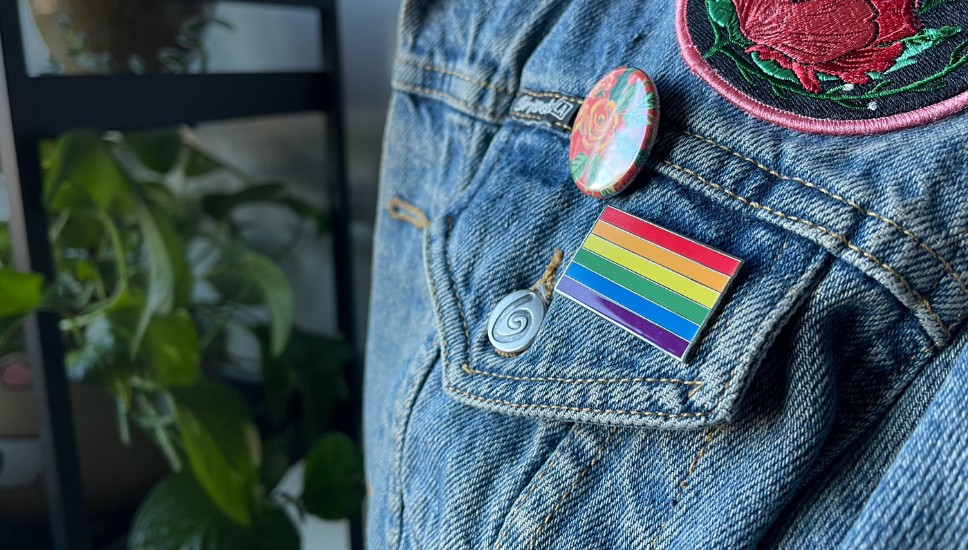 Rainbow Pride Flag Enamel Pin on a jean jacket