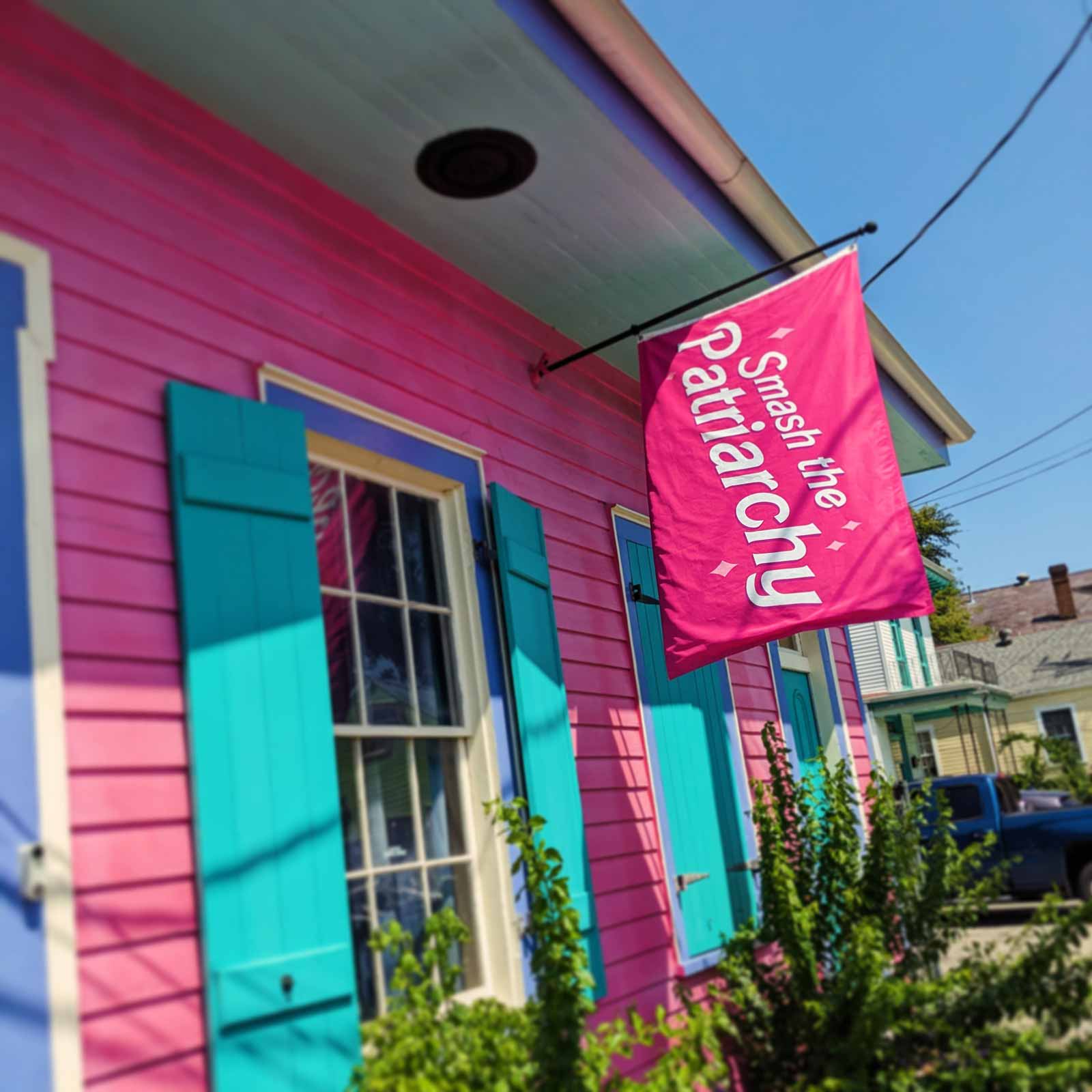 Pink "smash the patriarchy" flag on a pink house