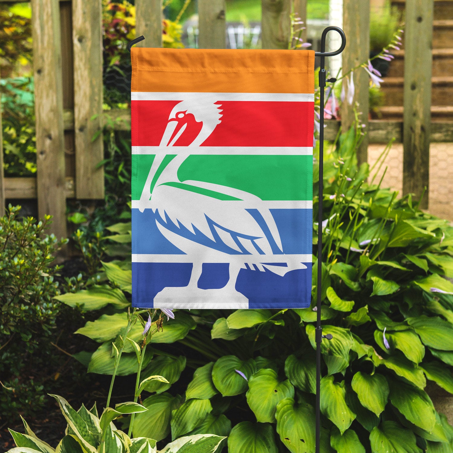 Garden flag of St. Petersburg Florida on a garden stake pole in front of plants