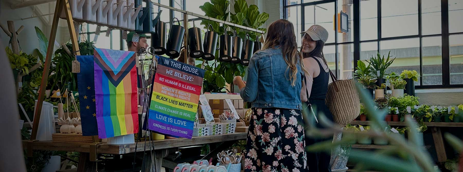 Flags For Good Garden Flags in a plant store with two women smiling