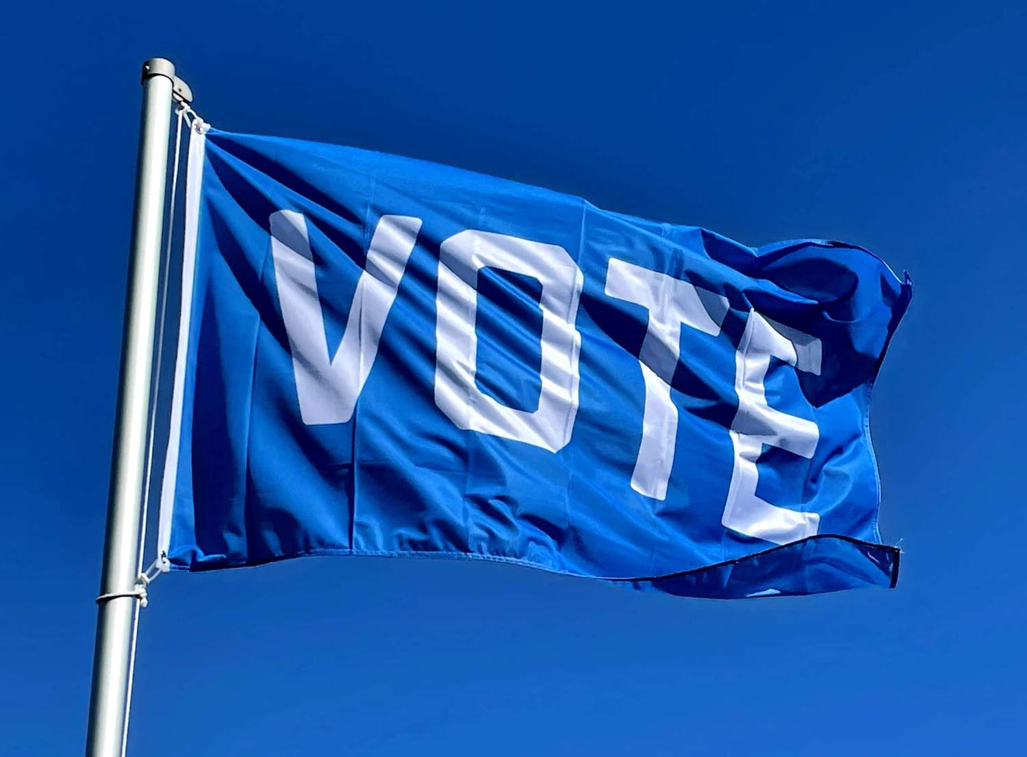 Blue "Vote" Flag by Flags For Good on a flag pole