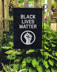 BLM garden flag placed in a garden