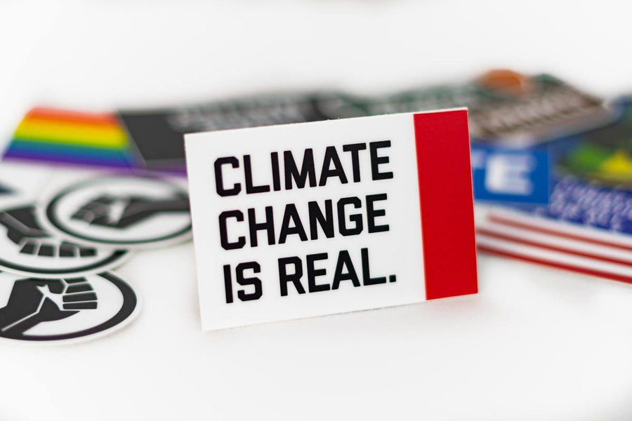 Climate Change Is Real Sticker among other assorted stickers