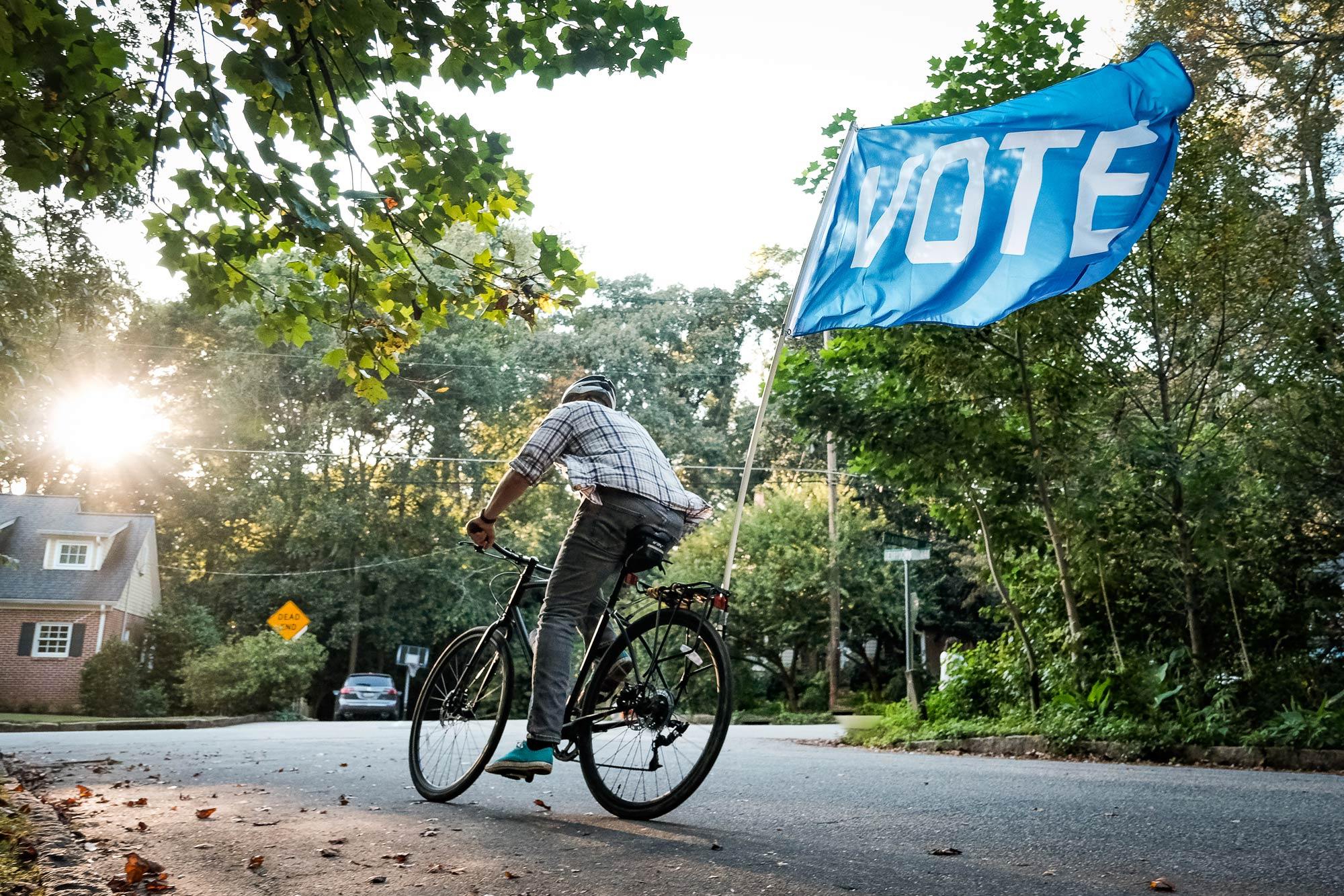 Vote Flag being flown behind a bicycle by Flags For Good