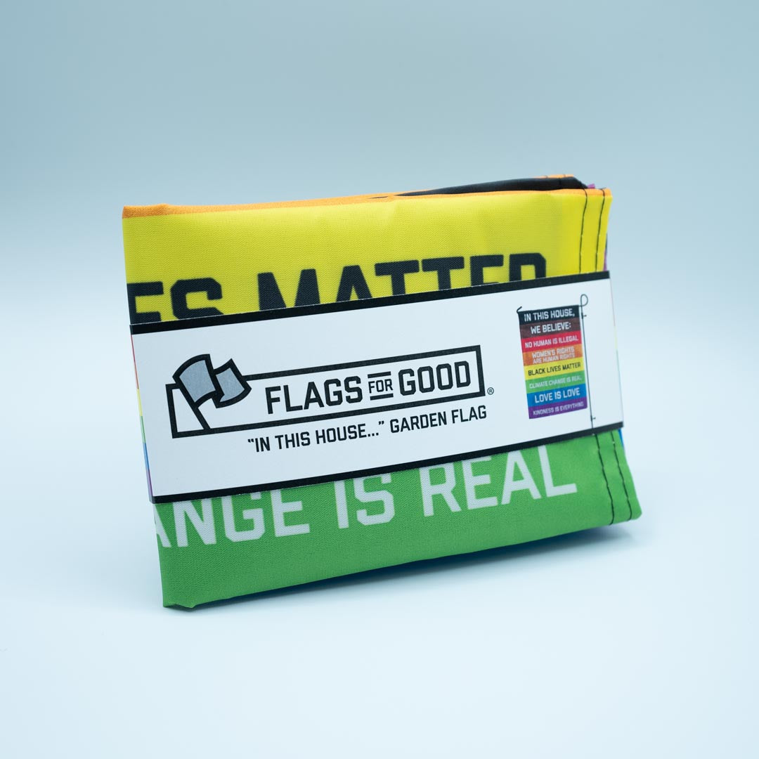 "In this House" garden flag in packaging