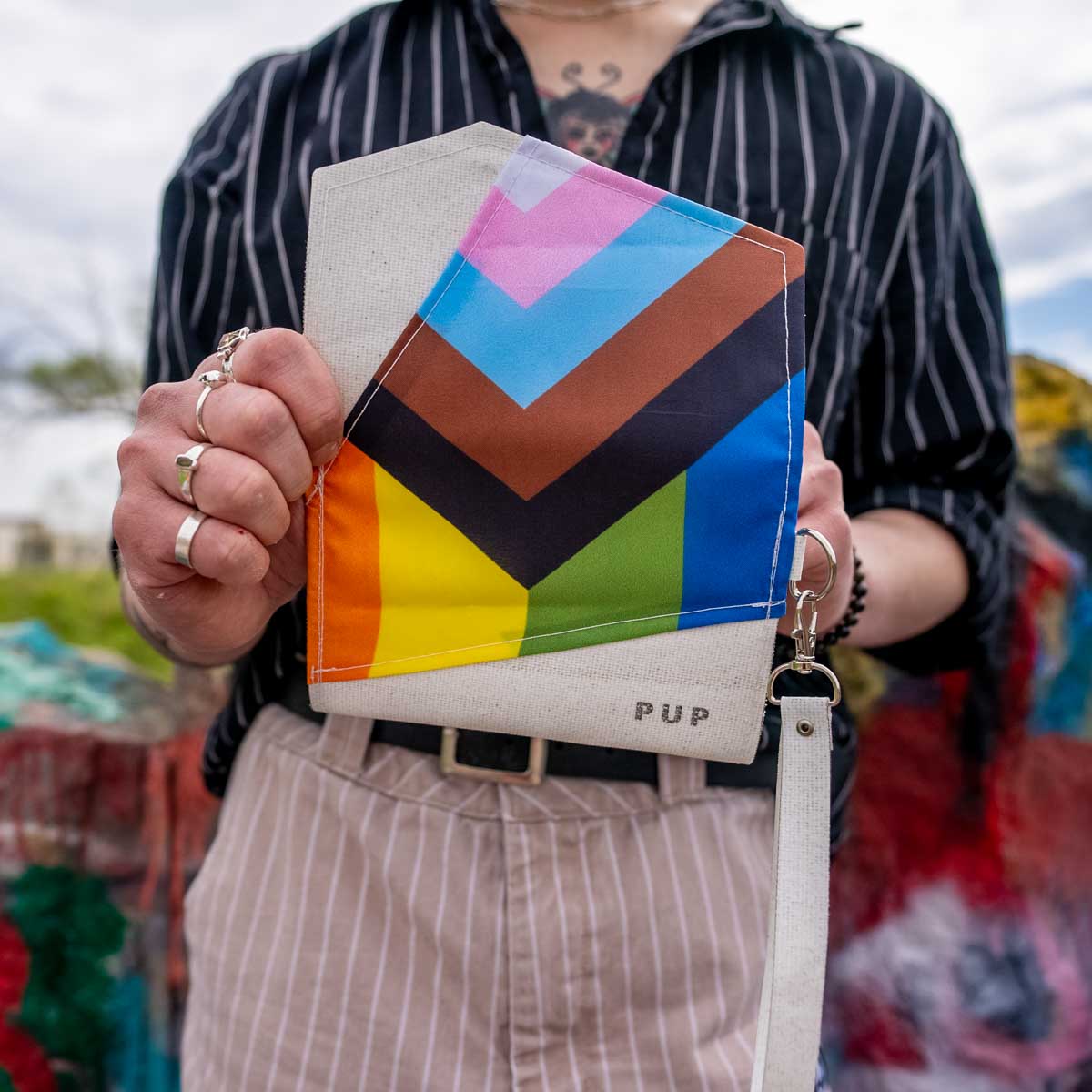 Upcycled Progress Pride Flag Wristlet being opened up - Flags For Good X PUP