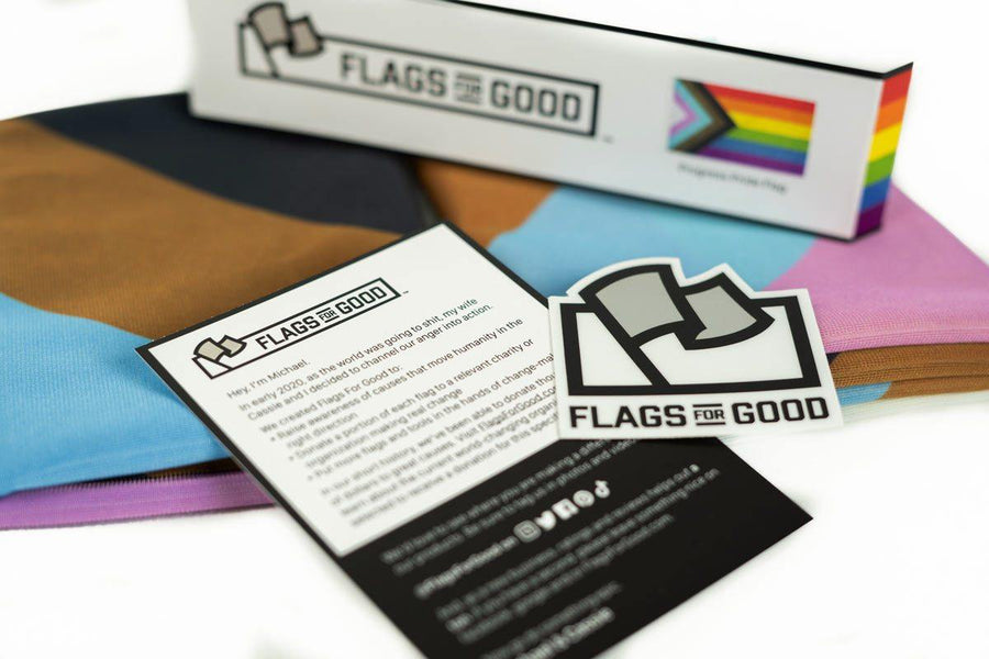 Progress Pride Flag by Flags For Good unfolded showing the insert and sticker