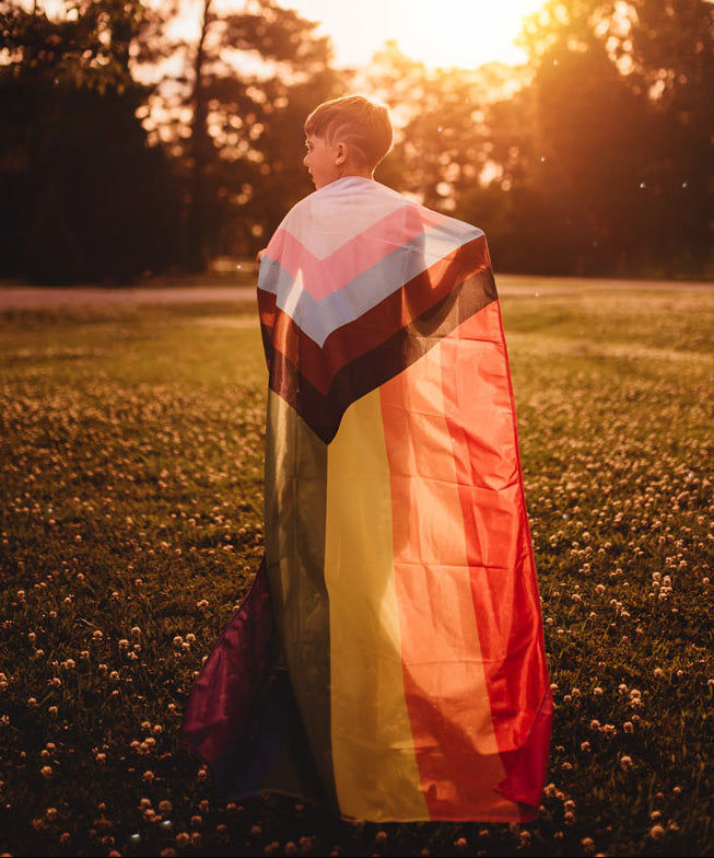 Progress Pride Flag on the back of a child