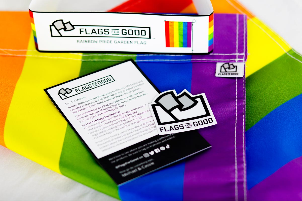6-Stripe Rainbow LGBTQ+ Pride Garden Flag by Flags For Good unfolded showing the insert card and sticker