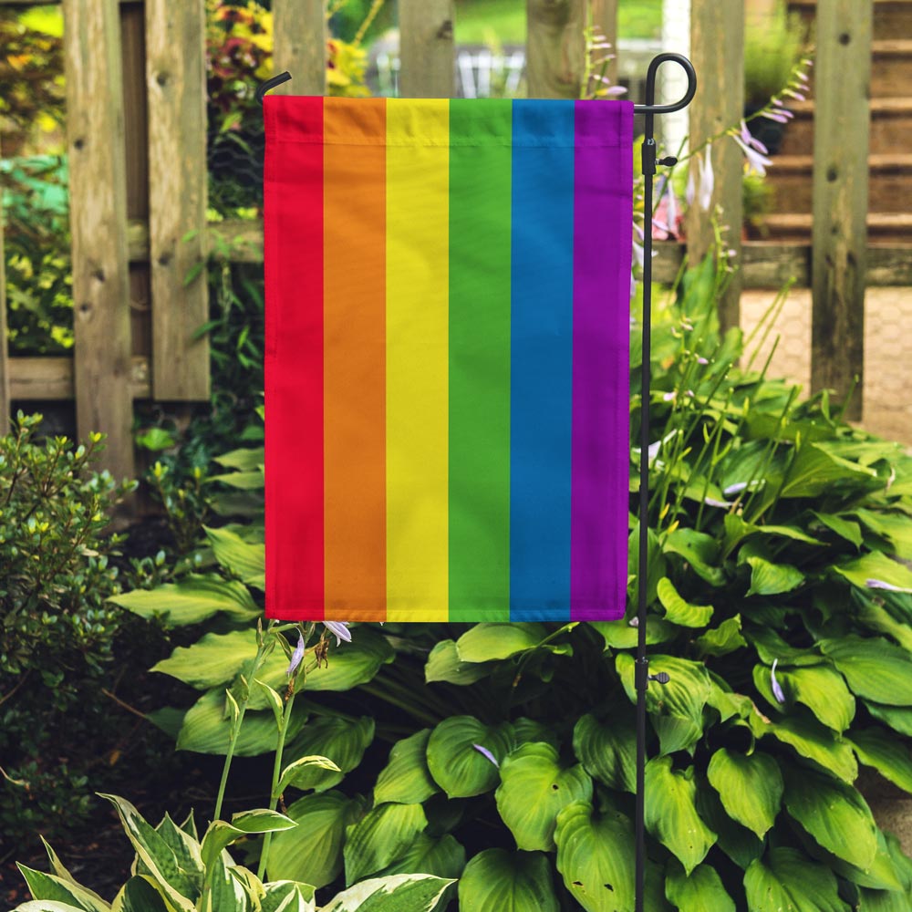 6-Stripe Rainbow LGBTQ+ Pride Garden Flag by Flags For Good in a garden